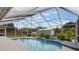 Beautiful screened-in pool and spa surrounded by lush landscaping, a perfect backyard retreat at 2113 Kirkland Lake Dr, Auburndale, FL 33823