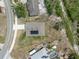 Aerial view of a home with solar panels, a paved driveway and a well-manicured lawn at 2135 E Old Mill Dr, Deltona, FL 32725