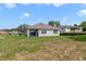 Home featuring a spacious backyard with healthy lawn and a patio at 2135 E Old Mill Dr, Deltona, FL 32725