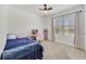 Comfortable bedroom featuring carpet, ceiling fan, and a bright window for natural light at 2135 E Old Mill Dr, Deltona, FL 32725