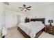 Bright Primary bedroom with a large bed, a window with blinds, and a dresser, creating a comfortable retreat at 2135 E Old Mill Dr, Deltona, FL 32725