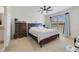 Bedroom featuring a large bed, a window with natural light, and a dresser, creating a cozy and inviting space at 2135 E Old Mill Dr, Deltona, FL 32725