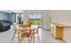 Bright dining area with a wooden table, chairs, and sliding glass doors leading to the backyard at 2135 E Old Mill Dr, Deltona, FL 32725