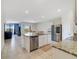 Open-concept kitchen with granite countertops, a kitchen island with seating, and stainless steel appliances at 2135 E Old Mill Dr, Deltona, FL 32725