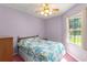 Bedroom with a large window and a floral-patterned bedspread offers natural light and a relaxing atmosphere at 216 Bermuda Petrel Ct, Daytona Beach, FL 32119