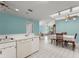 Kitchen featuring white cabinetry and seamless flow into the dining room perfect for entertaining guests at 216 Bermuda Petrel Ct, Daytona Beach, FL 32119