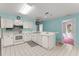 Kitchen with tiled floors and white cabinetry, modern appliances, and a convenient breakfast bar area at 216 Bermuda Petrel Ct, Daytona Beach, FL 32119