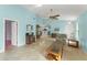 Spacious living room with tile flooring, a ceiling fan, and open access to the kitchen at 216 Bermuda Petrel Ct, Daytona Beach, FL 32119