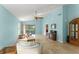 Bright living room featuring light blue walls, tile flooring, and a ceiling fan at 216 Bermuda Petrel Ct, Daytona Beach, FL 32119