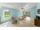 Light-filled living room with tile floors, neutral furniture, and sliding glass doors to the backyard at 216 Bermuda Petrel Ct, Daytona Beach, FL 32119