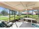 Enclosed patio with chairs and table offering a scenic view of the yard at 216 Bermuda Petrel Ct, Daytona Beach, FL 32119