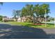 Street view of single-story homes with tile roofs, well-kept lawns, and mature shade trees at 216 Bermuda Petrel Ct, Daytona Beach, FL 32119