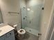 Well-lit bathroom with a quartz countertop vanity and a glass walk-in shower at 2322 Daisy Tree Rd, St Cloud, FL 34771