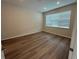 Empty bedroom featuring wood floors, recessed lighting, neutral walls and a large window at 2322 Daisy Tree Rd, St Cloud, FL 34771