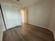 A simple bedroom featuring a closet and an entryway with neutral wall colors at 2322 Daisy Tree Rd, St Cloud, FL 34771