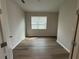 Bright bedroom with wood floors and a window with blinds at 2322 Daisy Tree Rd, St Cloud, FL 34771