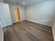 A modern bedroom featuring wood floors and neutral wall colors at 2322 Daisy Tree Rd, St Cloud, FL 34771