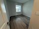 Bedroom with a window, wood-look floors, and neutral-colored walls at 2322 Daisy Tree Rd, St Cloud, FL 34771