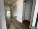 Hallway features wood flooring, neutral paint and an open doorway to the rest of the home at 2322 Daisy Tree Rd, St Cloud, FL 34771