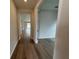 Entryway features wood flooring, neutral paint and an open doorway to the rest of the home at 2322 Daisy Tree Rd, St Cloud, FL 34771