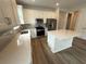 Bright kitchen with modern appliances, a center island, quartz countertops and a stylish backsplash at 2322 Daisy Tree Rd, St Cloud, FL 34771