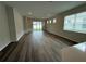 Bright living room area featuring wood flooring, neutral paint and sliding glass doors at 2322 Daisy Tree Rd, St Cloud, FL 34771