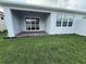Outdoor patio with sliding glass doors overlooks the lush backyard at 2322 Daisy Tree Rd, St Cloud, FL 34771