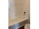 A white tiled bathtub with a silver faucet and shower head with a shower curtain rod at 238 Afton Sq # 106, Altamonte Springs, FL 32714