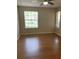 Bright bedroom with hardwood floors and a ceiling fan and natural light from large windows at 238 Afton Sq # 106, Altamonte Springs, FL 32714