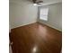 A bright bedroom featuring wood flooring and a ceiling fan at 238 Afton Sq # 106, Altamonte Springs, FL 32714