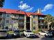 Condominium exterior with red roof, multiple floors, and convenient parking at 238 Afton Sq # 106, Altamonte Springs, FL 32714