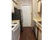 Galley kitchen with stainless steel refrigerator and white appliances at 238 Afton Sq # 106, Altamonte Springs, FL 32714