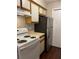 Galley kitchen with stainless steel refrigerator and white appliances at 238 Afton Sq # 106, Altamonte Springs, FL 32714