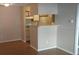 View of kitchen bar and appliances from neutral living area with wood floors at 238 Afton Sq # 106, Altamonte Springs, FL 32714
