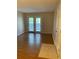 Neutral living area with wood floors, French doors and natural light at 238 Afton Sq # 106, Altamonte Springs, FL 32714
