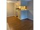 View of kitchen bar and appliances from neutral living area with wood floors at 238 Afton Sq # 106, Altamonte Springs, FL 32714