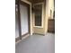 Exterior view of a small patio with brown trim doors and a light fixture at 238 Afton Sq # 106, Altamonte Springs, FL 32714