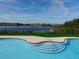Stunning pool that overlooks the lake with a fence and grassy area at 238 Afton Sq # 106, Altamonte Springs, FL 32714