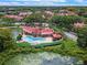 Aerial view of a community with pool, tennis court, and pond at 238 Afton Sq # 204, Altamonte Springs, FL 32714