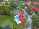 Aerial view of community pool, tennis courts, and red-roofed buildings at 238 Afton Sq # 204, Altamonte Springs, FL 32714
