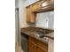 Kitchen showcasing a stainless steel dishwasher and double sink with wood cabinetry at 238 Afton Sq # 204, Altamonte Springs, FL 32714