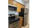 This kitchen features stainless steel appliances and wood cabinets for a modern look at 238 Afton Sq # 204, Altamonte Springs, FL 32714