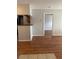 Open-concept living room with wood floors transitions seamlessly into the kitchen area at 238 Afton Sq # 204, Altamonte Springs, FL 32714
