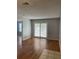 Bright living room featuring wood floors and sliding glass doors for ample natural light at 238 Afton Sq # 204, Altamonte Springs, FL 32714