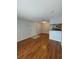 Living room with wood floors, a view into the kitchen and the front door with a tiled landing at 238 Afton Sq # 204, Altamonte Springs, FL 32714