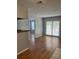 The living room boasts wood floors and a view towards the kitchen and a sliding glass door at 238 Afton Sq # 204, Altamonte Springs, FL 32714