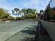 Community tennis court with mature trees in the background and a partial view of the complex at 238 Afton Sq # 204, Altamonte Springs, FL 32714