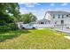 Spacious fenced backyard with lush lawn, shade trees, and charming detached garage at 2505 Amherst Ave, Orlando, FL 32804