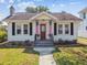 Charming home featuring a landscaped front yard, sidewalk, and quaint details at 2505 Amherst Ave, Orlando, FL 32804