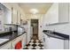 View of kitchen with black and white tile, white cabinets and lots of storage at 2505 Amherst Ave, Orlando, FL 32804